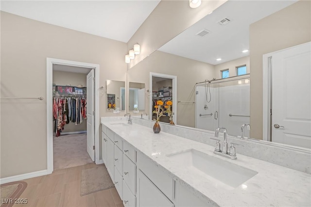 7177 W Camero Ave, Las Vegas, NV 89113 - full bathroom with visible vents, a sink, a shower stall, and double vanity
