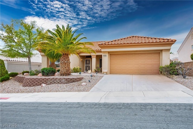 view of front of home featuring a garage, concrete driveway, and stucco siding