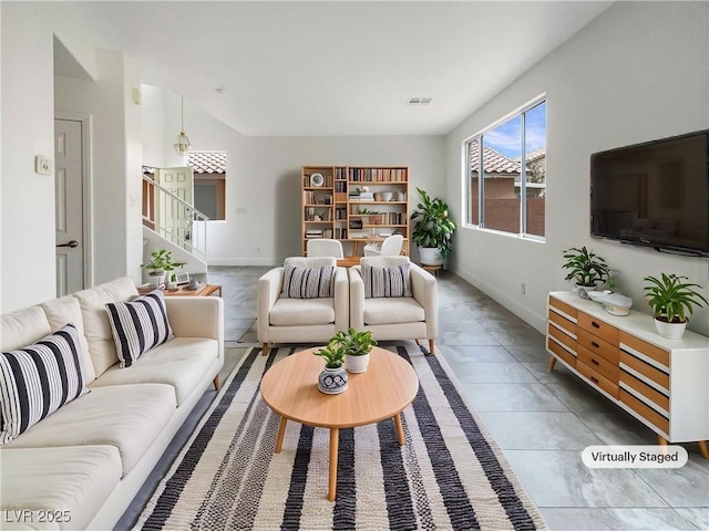 living room with light tile patterned floors, baseboards, stairs, and visible vents