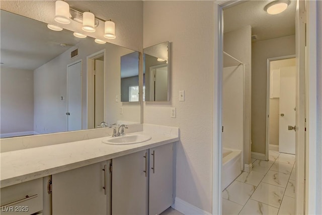 bathroom with baseboards, visible vents,  shower combination, marble finish floor, and vanity