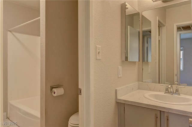 full bathroom with a textured wall, toilet, vanity, a tub, and walk in shower