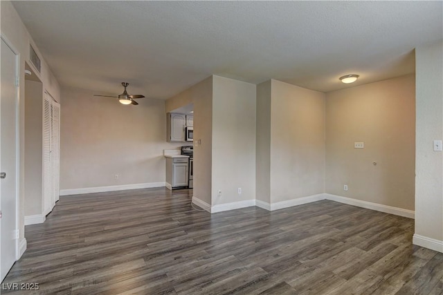 unfurnished living room featuring baseboards, visible vents, a ceiling fan, and dark wood-type flooring