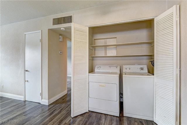 laundry area with washing machine and dryer, laundry area, visible vents, baseboards, and dark wood-style floors