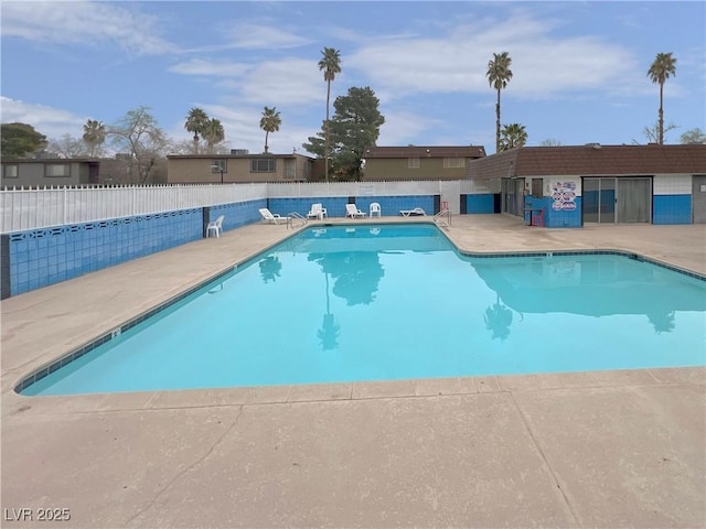 pool with fence and a patio