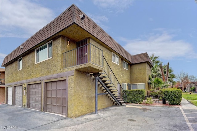 exterior space with a garage and stairway