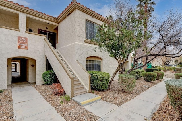 view of front of house featuring stucco siding and a tiled roof