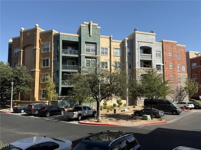 view of property featuring uncovered parking