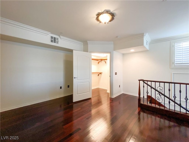 bedroom featuring baseboards, dark wood-type flooring, visible vents, and crown molding