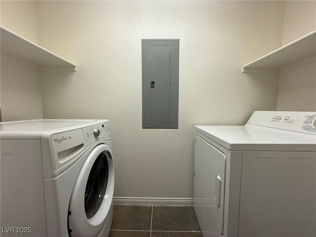 laundry area with laundry area, electric panel, washer and clothes dryer, and baseboards