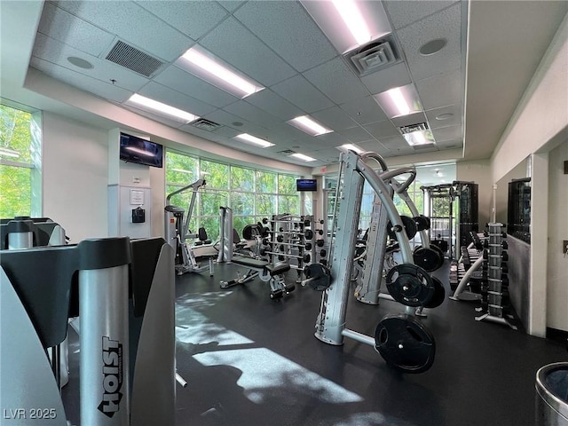 exercise room with a drop ceiling and visible vents