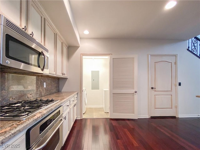 kitchen featuring electric panel, dark wood-style floors, appliances with stainless steel finishes, backsplash, and recessed lighting