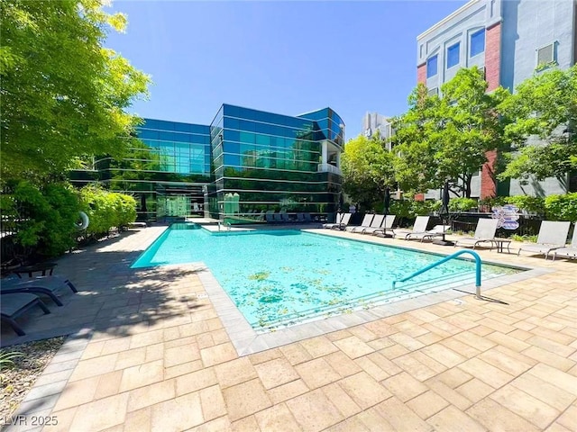 community pool with fence and a patio