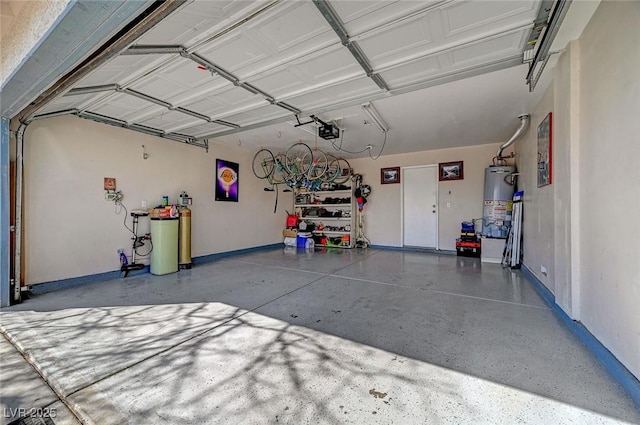 garage featuring water heater, baseboards, and a garage door opener