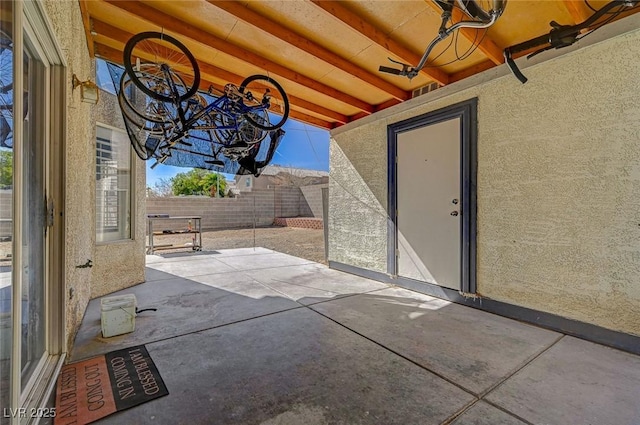 view of patio featuring fence