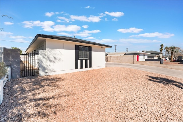 rear view of house featuring a gate