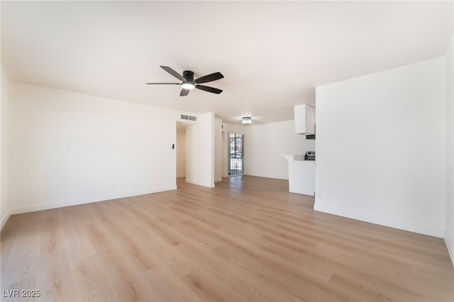 unfurnished room featuring light wood-style floors, visible vents, ceiling fan, and baseboards