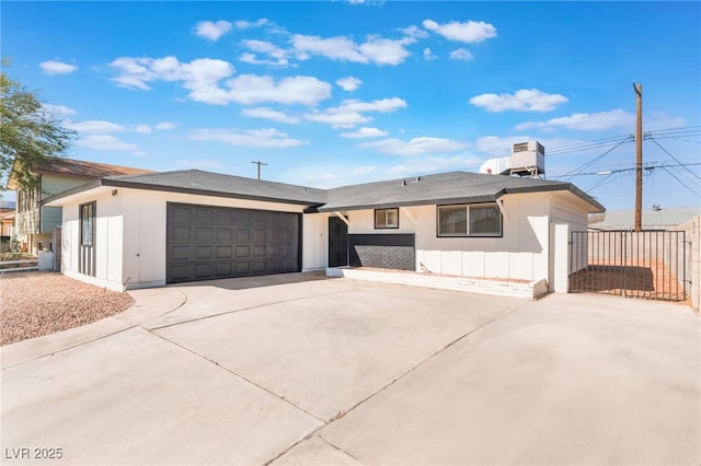 single story home featuring driveway, an attached garage, and fence