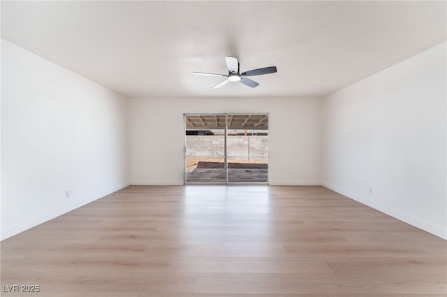 spare room with ceiling fan, light wood-style flooring, and baseboards