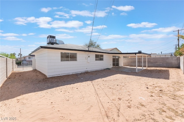 back of property with central air condition unit, a patio area, and a fenced backyard