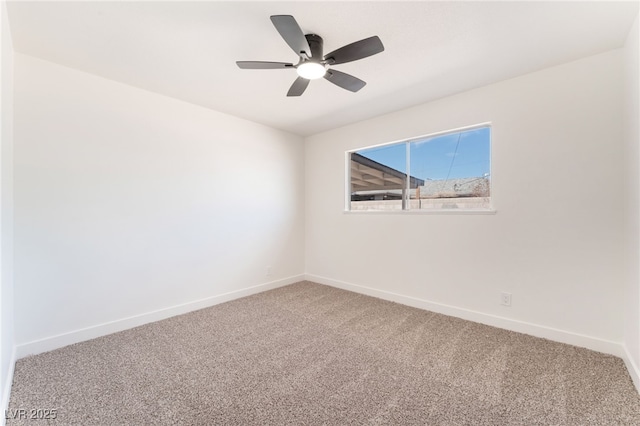 carpeted empty room with ceiling fan and baseboards