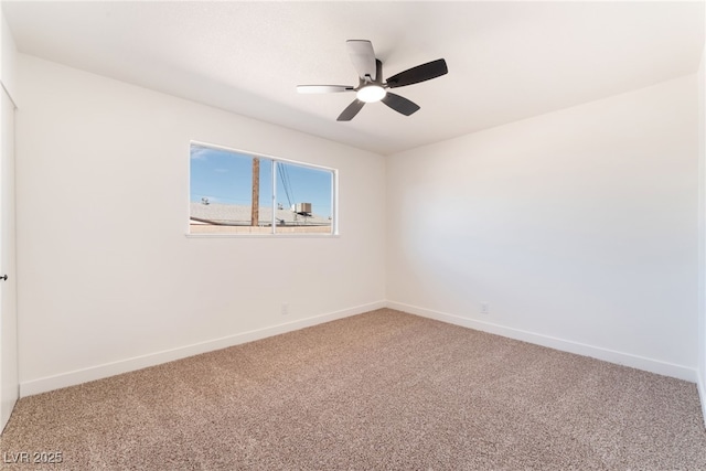 carpeted empty room with ceiling fan and baseboards