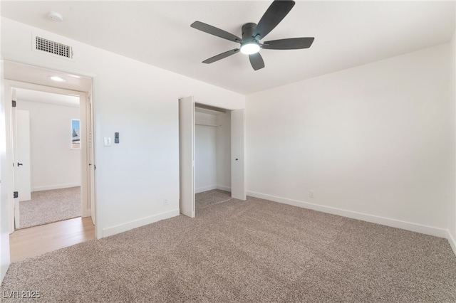 unfurnished bedroom with light carpet, baseboards, visible vents, and a ceiling fan