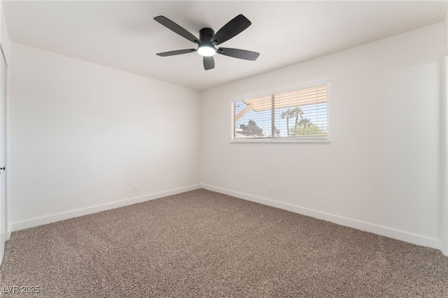 carpeted spare room with ceiling fan and baseboards