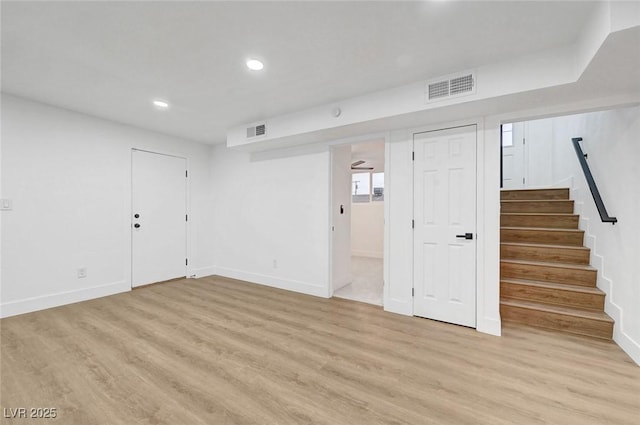 basement featuring stairs, light wood-style flooring, visible vents, and recessed lighting