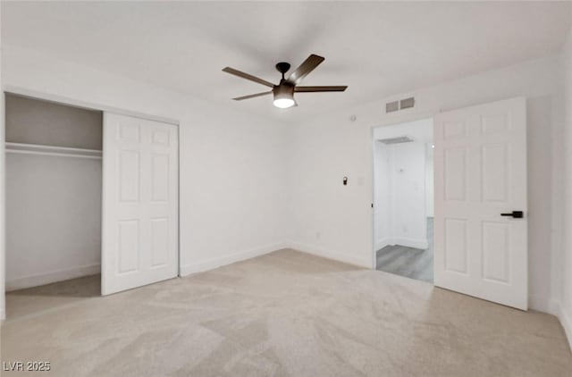 unfurnished bedroom with carpet floors, a closet, visible vents, and baseboards