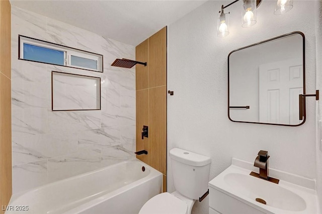 bathroom featuring bathtub / shower combination, a textured wall, vanity, and toilet