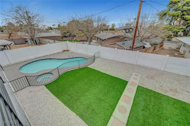 view of swimming pool featuring a patio area, a fenced backyard, a fenced in pool, and a yard