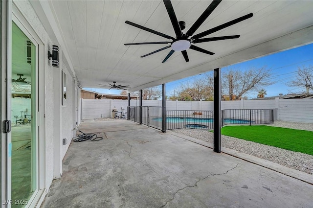 view of patio / terrace with a fenced in pool, a fenced backyard, and ceiling fan