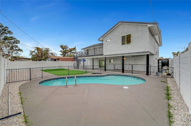 view of swimming pool featuring a fenced backyard, a jacuzzi, a fenced in pool, and a patio