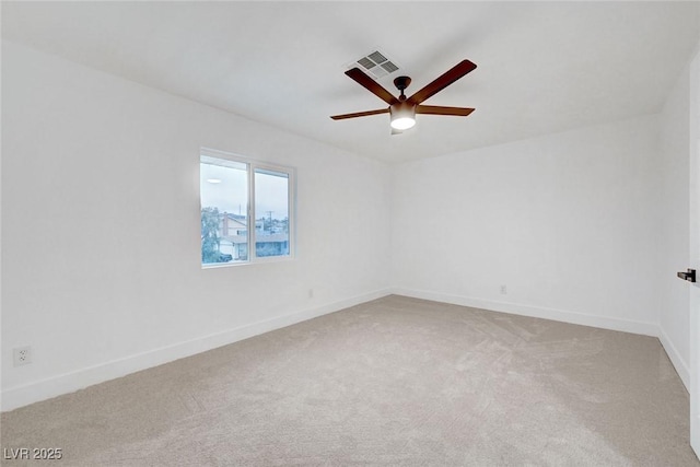 unfurnished room featuring light carpet, baseboards, visible vents, and ceiling fan