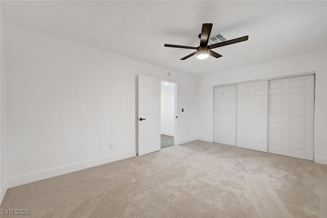 unfurnished bedroom with a closet, carpet flooring, visible vents, and baseboards