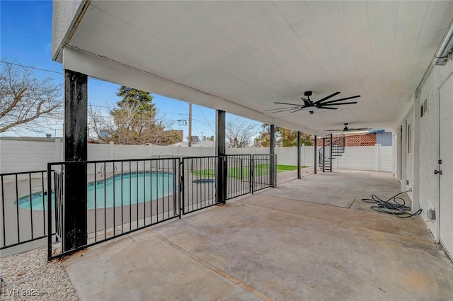 view of patio featuring a fenced backyard, a fenced in pool, and a ceiling fan