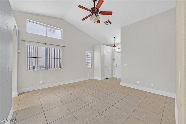 unfurnished room with lofted ceiling, visible vents, a ceiling fan, and baseboards