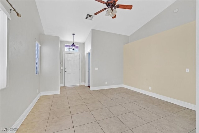 entrance foyer with light tile patterned floors, baseboards, visible vents, a ceiling fan, and lofted ceiling