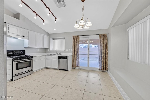 kitchen featuring appliances with stainless steel finishes, light countertops, under cabinet range hood, a sink, and light tile patterned flooring