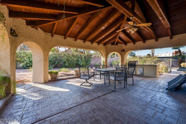 view of patio / terrace with ceiling fan, outdoor dining area, and fence