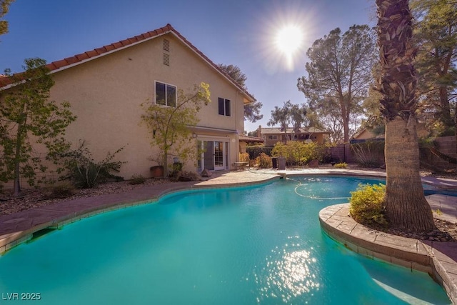 view of pool with a fenced in pool and fence