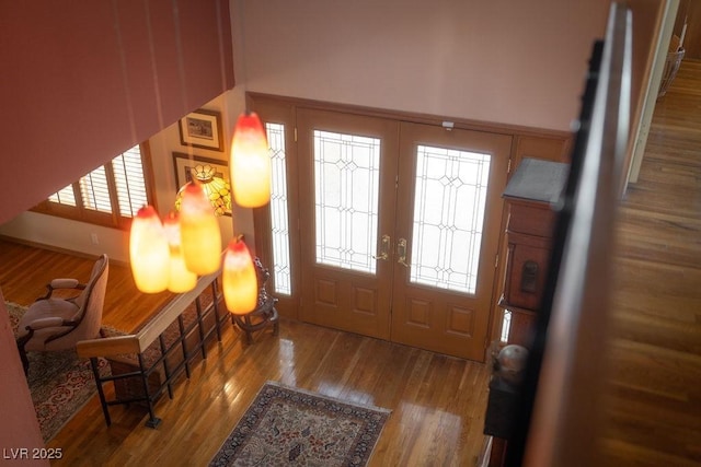 entrance foyer with a wealth of natural light, french doors, and wood finished floors