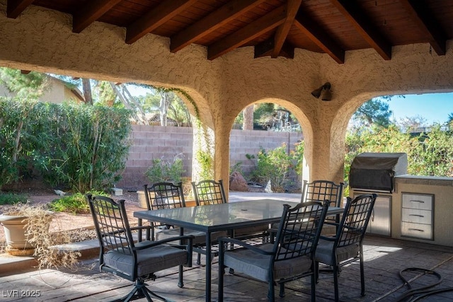 view of patio / terrace with outdoor dining space, fence, grilling area, and area for grilling