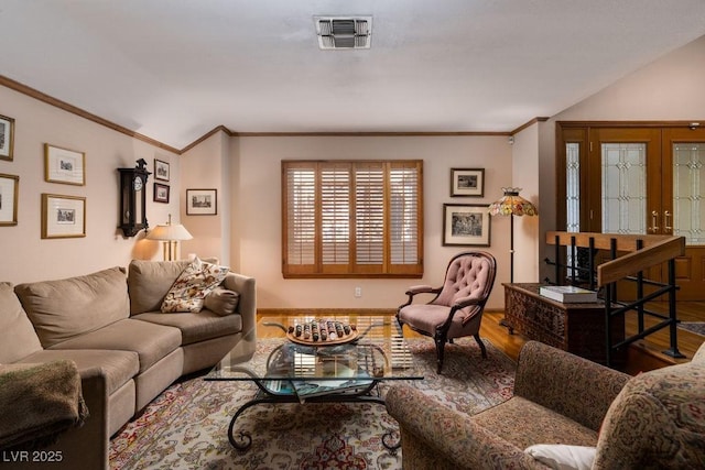 living room featuring ornamental molding, wood finished floors, and visible vents