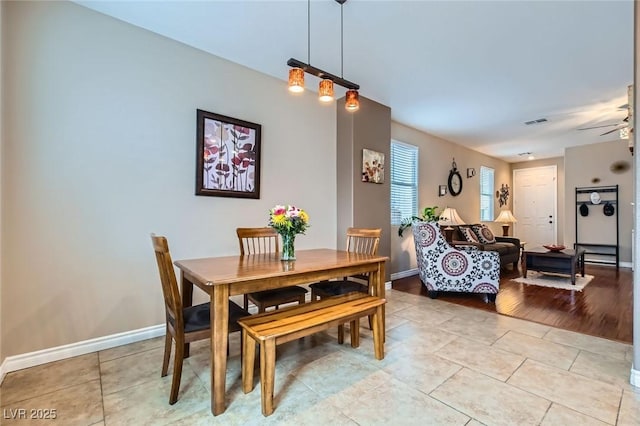 dining space with light tile patterned floors, baseboards, and visible vents