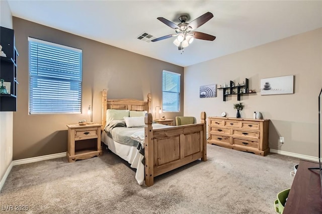 bedroom with light colored carpet, visible vents, ceiling fan, and baseboards