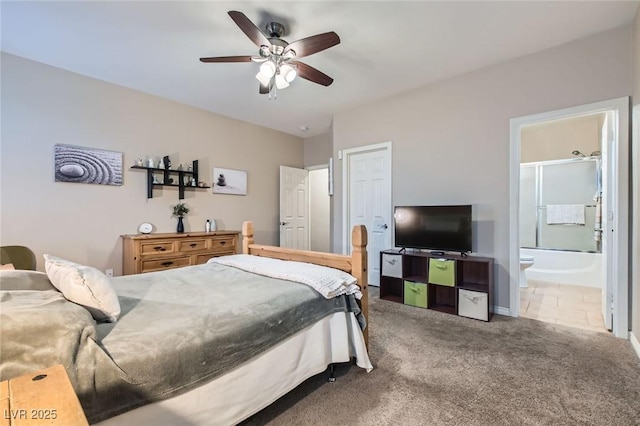 tiled bedroom with ceiling fan, carpet flooring, and connected bathroom