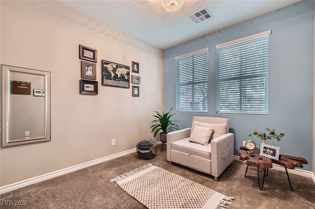 living area with carpet floors, baseboards, and visible vents