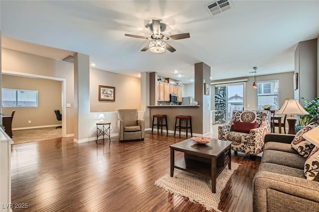 living area with ceiling fan, recessed lighting, wood finished floors, visible vents, and baseboards