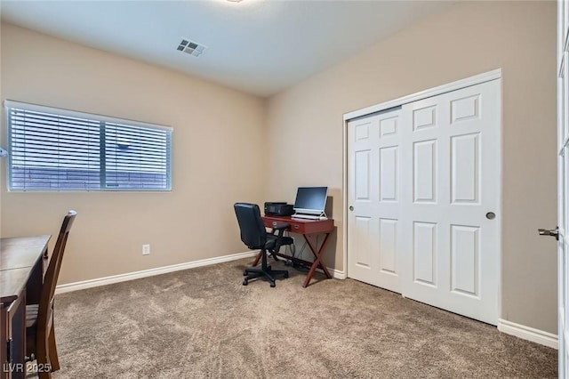 office area with carpet flooring, visible vents, and baseboards